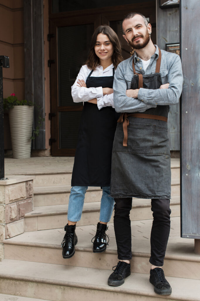 business partners posing with apron